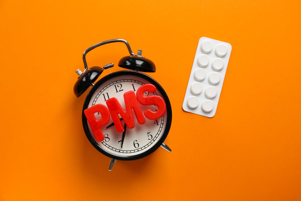 Clock, Pills and Word PMS on Color Background