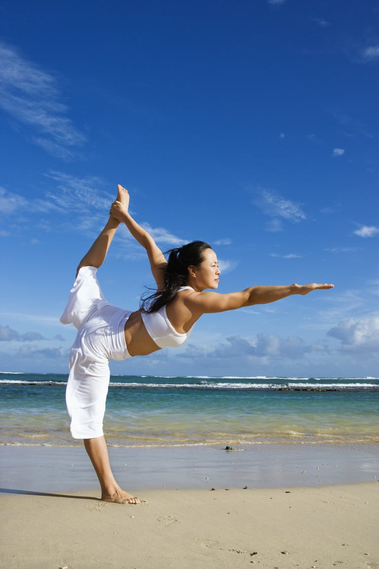 Woman Doing Yoga on Beach