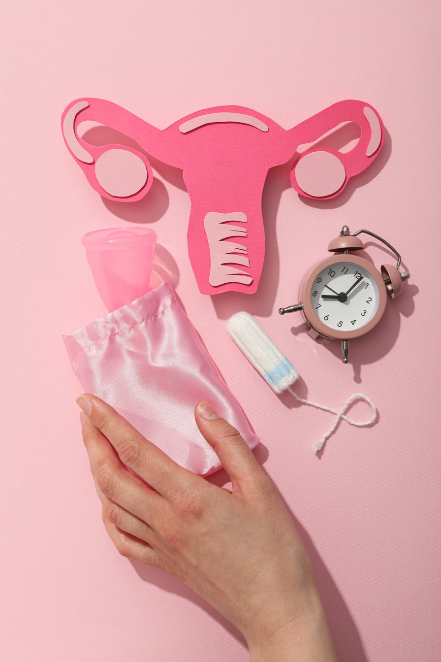 Menstrual feminine hygiene products on a pink background